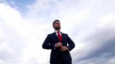 manager executive man in businesslike suit on sky background, male formal fashion.