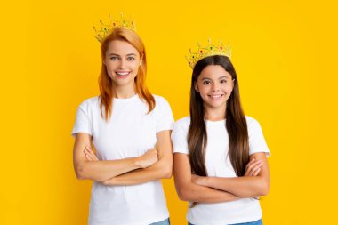 Happy woman mother and daughter child wearing crowns. Happy loving family. Mother and her daughter child girls playing in princess