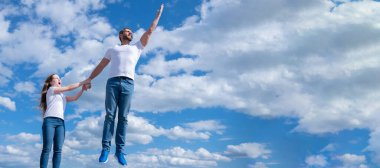 Father and daughter jumping in sky, banner with copy space