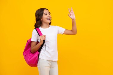 School girl in school uniform with school bag. Schoolchild teenager hold backpack on yellow isolated background