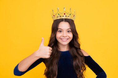 Girls birthday party, funny kid in crown. Imagine herself a queen, child wear diadem. Successful teenager wear luxury beauty queen crown, success. Happy face, positive and smiling emotions