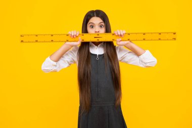 Back to school. Teenager school girl on isolated background. School supplies. Surprised face, surprise emotions of teenager schoolgirl