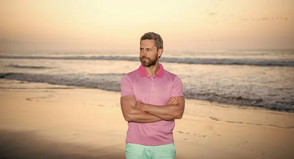 confident man over the sea on morning summer beach, seascape.