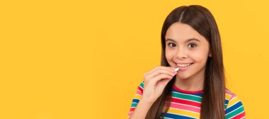 girl eat multivitamin. healthy lifestyle. childhood health. food supplement. Horizontal poster of isolated child face, banner header, copy space