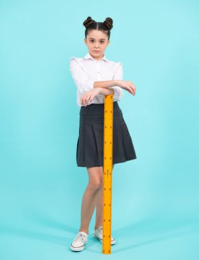Back to school. Teenager school girl on blue background. School supplies