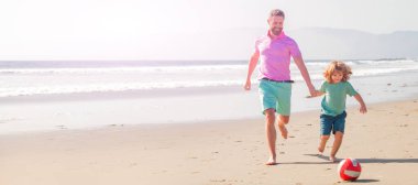 Banner of father and son play soccer or football on beach. father and son play football on beach. daddy with kid boy on summer day. weekend family day