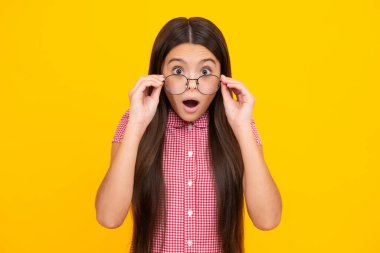 Shocked surprised teenager girl. Portrait of teenager child girl in glasses. Kid at eye sight test. Girl with eyeglasses and looking at camera. Vision for children