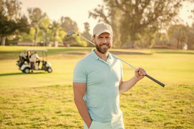 Profesyonel sahada yeşil çimenli neşeli erkek golfçü, sporcu.
