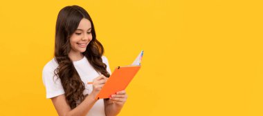 happy school child ready to study making notes in notepad, school. Banner of school girl student. Schoolgirl pupil portrait with copy space