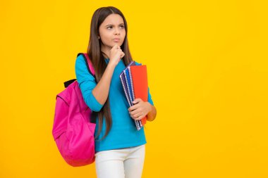 School teenager child 12, 13, 14 years old with book and copybook. Teenager schoolgirl on isolated background. Thinking face, thoughtful emotions of teenager girl