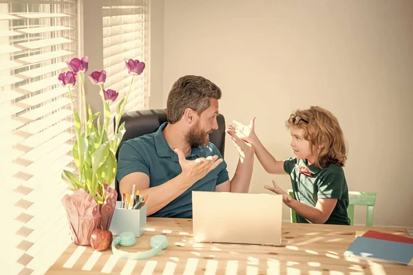 back to school. surprised father and son use modern technology at home. family blog. boy do homework with private teacher. webinar video lesson. online education on laptop. homeschooling and elearning