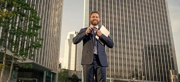 happy successful man in formalwear with computer outside the office, freelancer.