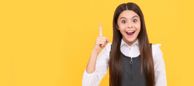 Got idea. Happy kid keep finger up yellow background. Idea. Eureka. Inspiration. Think big. Child face, horizontal poster, teenager girl isolated portrait, banner with copy space