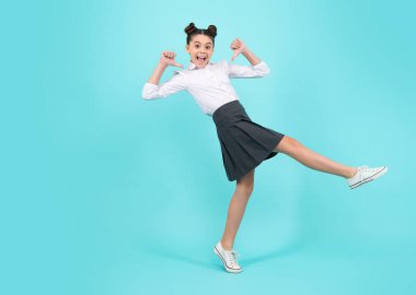 Amazed teenager. Happiness, freedom, motion and child. Young teenager girl wear summer dress jumping in air over blue background. Excited teen girl