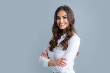 Happy smiling woman portrait. Attractive young pretty cheerful girl in casual clothing feeling happy and carefree, isolated gray background