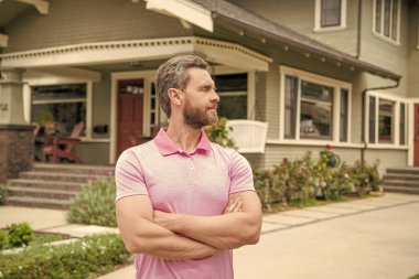 real estate agent sell property. realtor in suburb neighborhood. man purchasing house for investment purpose. property insurance services. ownership. confident american settlement agent.