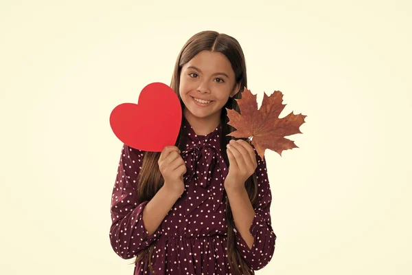 smiling child with autumn maple leaf and heart for valentines day holiday isolated on white, valentines sale.