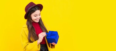 Teenager gift. Cute teenager child girl congratulate with valentines day, giving romantic gift box. Child with birthday gift, horizontal poster. Banner header with copy space