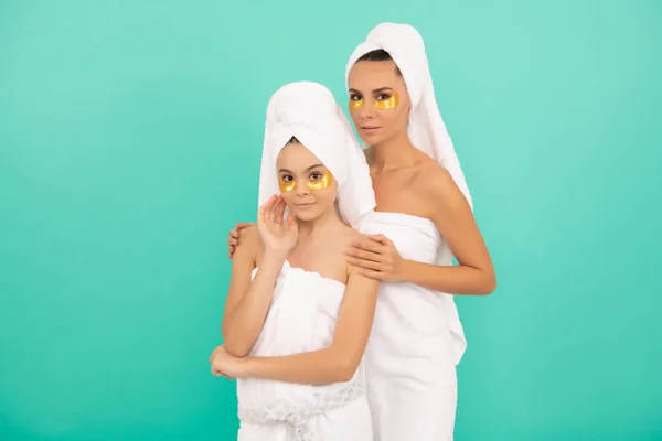 family spa of mother and daughter with golden patch.