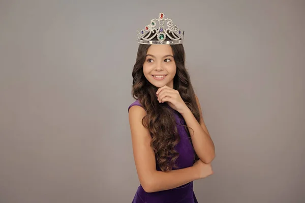 Teen child in queen crown isolated on gray background. Princess girl in tiara. Teenage girl wear diadem