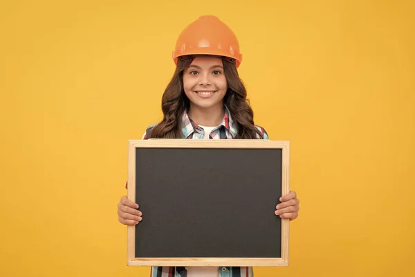 copy space for announcement. happy workers day. smiling teen girl laborer hold blackboard. child advertising labor day. back to school. kid presenting novelty information. childhood education.