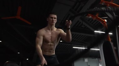 fitness gym. sportsman practice fitness with battle ropes. active sportsman training with battle ropes in fitness gym.