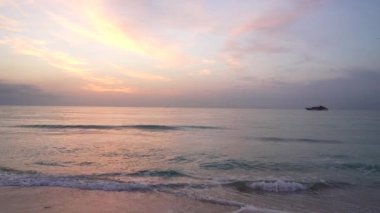 summer beach on sunset sky with yacht, romantic view.