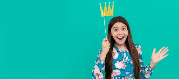 Happy surprise for princess. Surprised princess blue background. Funny girl hold prop crown. Child queen princess in crown horizontal poster design. Banner header, copy space