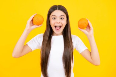 Happy teenager girl in t-shirt hold grapefruit orange, kids fruits vitamin. Smiling girl