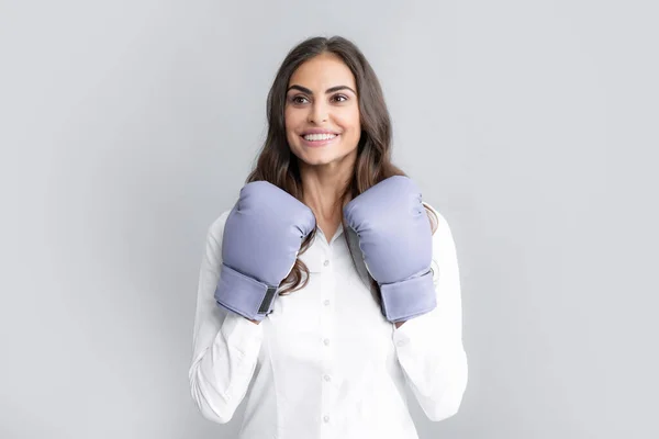 Business woman wearing boxing gloves ready to fight. Strength, power or competition concept. Woman in boxing gloves