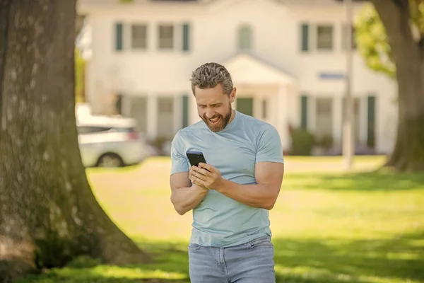 happy broker. mortgage insurer. american sales manager. real estate agent at house for sale. realtor work online on smartphone. rent or buy new home. home insure. property insurance promotion.