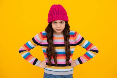 Winter hat. Cold season concept. Winter fashion accessory for children. Teen girl wearing warm knitted hat. Unhappy sad teenager girl
