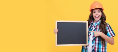 Renovation child, kid presenting novelty information. childhood education. copy space for announcement. Child builder in helmet horizontal poster design. Banner header, copy space