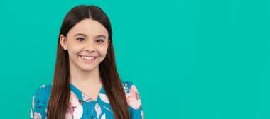 Happy school-aged child smile blue background. Child face, horizontal poster, teenager girl isolated portrait, banner with copy space