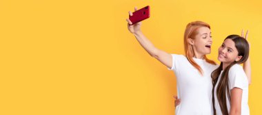 Mother and daughter kid banner, copy space, isolated background. modern life. mobile technology. having video call. mother and daughter vlogging