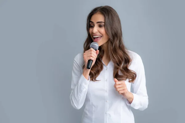 Woman speech, business woman holding a microphone. Portrait of young woman journalist in casual shirt holding microphone, asking questions, discussing problems, interviewing