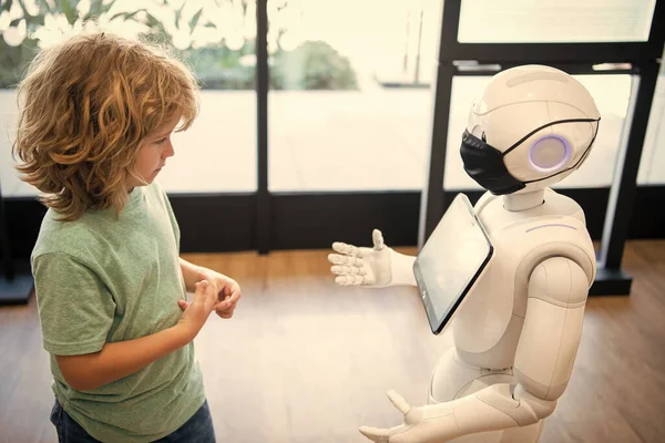 concentrated child interact with robot artificial intelligence, communication.