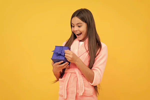 surprised teen girl in home terry bathrobe open gift or present box, surprise.