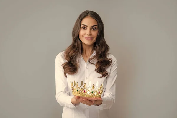 Portrait of woman queen. Gorgeous girl with crown. Party celebration concept. Close-up portrait of charming smiling lovely girl holding queen crown, gray background