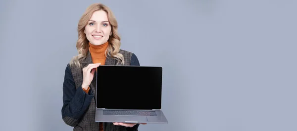 It is made for you. Computer user hold open laptop grey background. PC portable personal computer. Woman portrait, isolated header banner with copy space