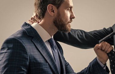 Professional man broker pull male necktie during physical fighting grey background, fight.
