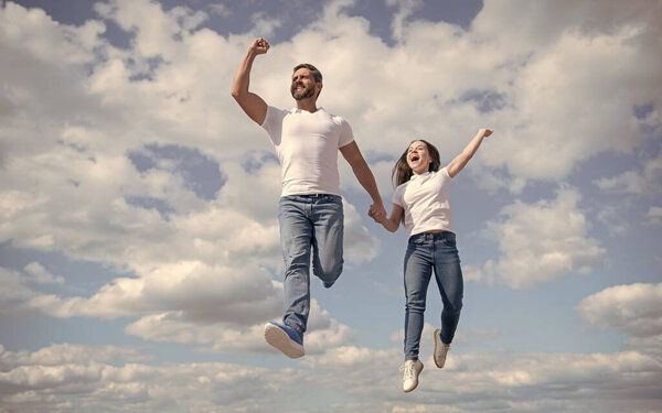 happy father and daughter jump in sky. bright future.