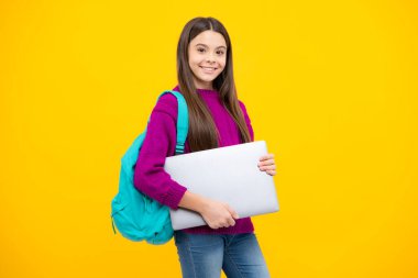 Teen schoolgirl hold laptop on isolated studio background. Cchool student learning online, webinar, video lesson, distance education
