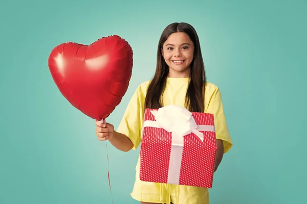 Love valentines, heart balloon. Happy girl face, positive and smiling emotions. Teenager kid with present box. Teen girl giving birthday gift. Present, greeting and gifting concept