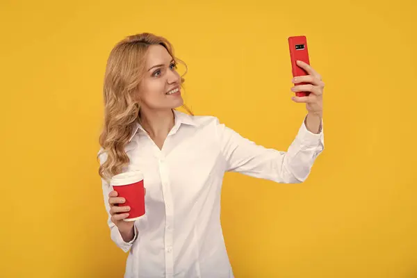Cheerful Blonde Woman Coffee Cup Making Selfie Phone Yellow Background — Stockfoto