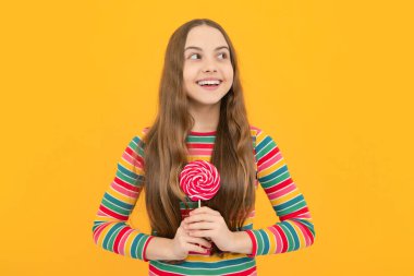Teenage girl with lollipop, child eating sugar lollipops, kids sweets candy shop