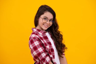 Happy teenager, positive and smiling emotions of teen girl. Emotional portrait of caucasian teenager child girl isolated on studio yellow background
