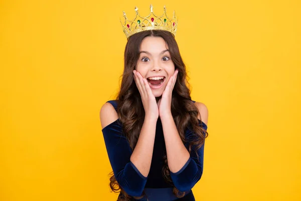 stock image Teenager princess child celebrates success win and victory. Teen girl in queen crown. Excited teenager girl