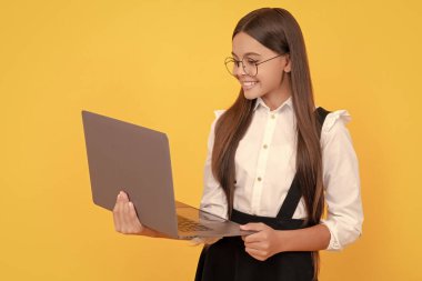 cheerful child study online. computer vision syndrome. nerd typing school blog. impact of computer on vision. kid in glasses. teen girl use laptop for communication. modern education. back to school.