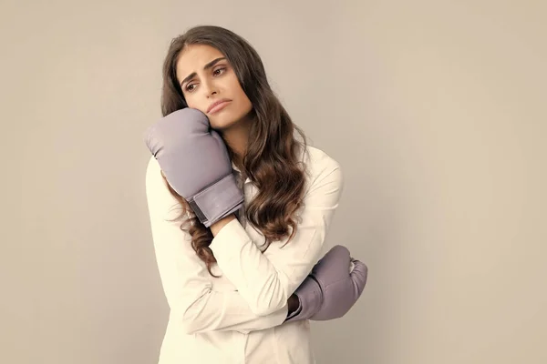 Sad tired woman in boxing gloves. Girl boxer posing with gloves